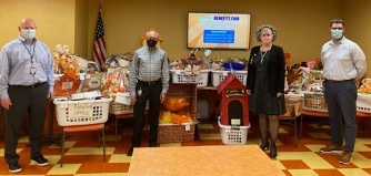 From L-R: Metro Credit Union employees Jim Herndon, SVP Human Resources; Robert Cashman, Chief Executive Officer; Marie O’Neill, SVP Engagement, Experience and Marketing; and Erik Porter, SVP Chief Financial Officer with the organization’s Thanksgiving baskets